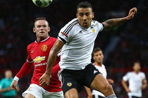 MANCHESTER, ENGLAND - AUGUST 12: Wayne Rooney of Manchester United in action with  Nicolas Otamendi of Valencia during the Pre Season Friendly match between Manchester United and Valencia at Old Trafford on August 12, 2014 in Manchester, England.  (Photo by Clive Brunskill/Getty Images)