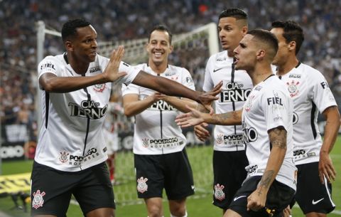 Corinthians' Jo, left, celebrates his first goal against Fluminense with teammates during a Brasileirao championship soccer match in Sao Paulo, Brazil, Wednesday, Nov. 15, 2017. Joe scored two of Corinthians' three goals against Fluminense' one, a victory that won his team the championship title. (AP Photo/Andre Penner)
