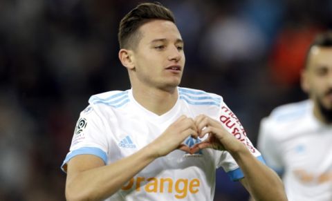 FILE - In this Sunday, Nov. 5, 2017 file photo, Marseille's Florian Thauvin celebrates after scoring during the League One soccer match between Marseille and Caen, at the Velodrome stadium, in Marseille, southern France. With Paris Saint-Germain streaking away at the top of the French league, the scrap for an automatic Champions League place promises to be an intense scrap between Monaco, Lyon and Marseille. (AP Photo/Claude Paris, File)