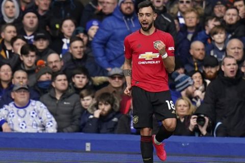 Manchester United's Bruno Fernandes celebrates after scoring his side's first goal during the English Premier League soccer match between Everton and Manchester United at Goodison Park in Liverpool, England, Sunday, March 1, 2020. (AP Photo/Jon Super)