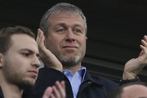 FILE - In this Saturday, March 22, 2014 file photo, Chelsea's Russian owner Roman Abramovich applauds his players after they defeated Arsenal 6-0, in the English Premier League soccer match between Chelsea and Arsenal at Stamford Bridge stadium in London. The Trump administration has released a list of 114 Russian politicians and 96 "oligarchs" it says are linked to Russian President Vladimir Putin, but its decided not to issue any extra sanctions for now. Perhaps best known internationally as the owner of Chelsea soccer club, billionaire businessman Abramovich made his fortune in oil and aluminum during the chaotic years which followed the collapse of the Soviet Union in 1991. (AP Photo/Alastair Grant, File)