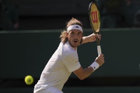 Stefanos Tsitsipas of Greece returns to Britain's Andy Murray in a men's singles match on day five of the Wimbledon tennis championships in London, Friday, July 7, 2023. (AP Photo/Alberto Pezzali)