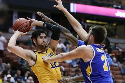 UC Irvine's Ioannis Dimakopoulos, left, looks to pass under pressure from UC Riverside's Alex Larsson, right, and Secean Johnson during the second half of an NCAA college basketball game at the Big West conference men's tournament Thursday, March 9, 2017, in Anaheim, Calif. UC Irvine won 76-67. (AP Photo/Jae C. Hong)