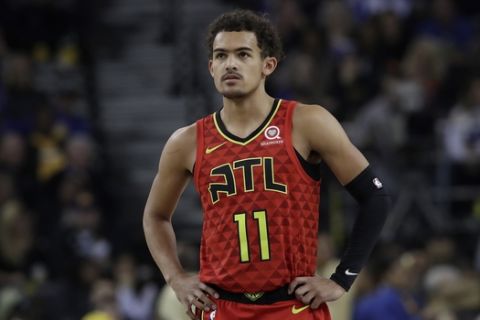 Atlanta Hawks guard Trae Young (11) against the Golden State Warriors during the first half of an NBA basketball game in Oakland, Calif., Tuesday, Nov. 13, 2018. (AP Photo/Jeff Chiu)