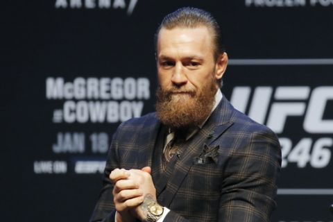 Conor McGregor motions to the crowd during a news conference for a UFC 246 mixed martial arts bout, Wednesday, Jan. 15, 2020, in Las Vegas. McGregor is scheduled to fight Donald "Cowboy" Cerrone in a welterweight bout Saturday. (AP Photo/John Locher)
