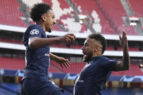 PSG's Marquinhos celebrates with PSG's Neymar, right, after scoring his side's first goal during the Champions League semifinal soccer match between RB Leipzig and Paris Saint-Germain at the Luz stadium in Lisbon, Portugal, Tuesday, Aug. 18, 2020. (David Ramos/Pool Photo via AP)