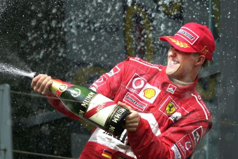 FILE - The March 3, 2002 file photo shows Ferrari's Michael Schumacher of Germany spraying champagne during podium celebrations at the Australian Formula One Grand Prix in Melbourne, Australia. Seven-time world champion Michael Schumacher  confirmed Thursday Oct. 4, 2012 that he will retire for good at the end of current Formula One season. (AP Photo/Ross Land, file)