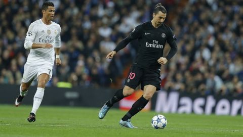 PSG's Zlatan Ibrahimovic, right, controls the ball as Real Madrid's Cristiano Ronaldo looks on during the Champions League group A soccer match between Real Madrid and PSG at the Santiago Bernabeu stadium in Madrid, Tuesday, Nov. 3, 2015. (AP Photo/Francisco Seco)