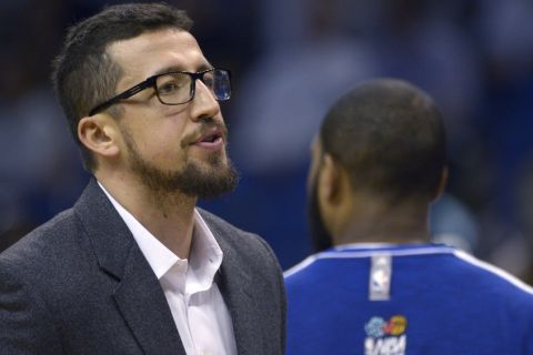 Orlando Magic forward Hedo Turkoglu, left, looks to the stands while standing outside the team huddle during the second half of an NBA basketball game against the Detroit Pistons in Orlando, Fla., Sunday, Jan. 27, 2013.(AP Photo/Phelan M. Ebenhack)
