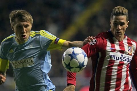 Astana's Kazakh defender Evgeni Postnikov (L) vies for the ball with Atletico Madrid's forward Fernando Torres during the UEFA Champions League group C football match between FC Astana and Club Atletico de Madrid at the Astana Arena stadium in Astana on November 3, 2015. AFP PHOTO / STANISLAV FILIPPOV        (Photo credit should read STANISLAV FILIPPOV/AFP/Getty Images)