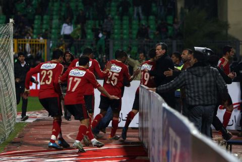 Egyptian Al-Ahly players escape from the field as fans of Al-Masry team rush to the pit during clashes that erupted after a football match between the two teams in Port Said, 220 kms northeast of Cairo, on February 1, 2012. At least 40 people were killed and hundreds injured according to medical sources. AFP PHOTO/STR (Photo credit should read -/AFP/Getty Images)