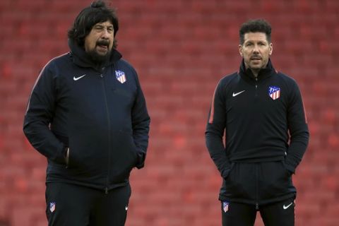 Atletico Madrid manager Diego Simeone, right, and assistant coach German Burgos look on during a soccer squad training session at Emirates Stadium in London, Wednesday, April 25, 2018. Atletico Madrid faces Arsenal in a Europa League match on Thursday.  (Adam Davy/PA Wire)
