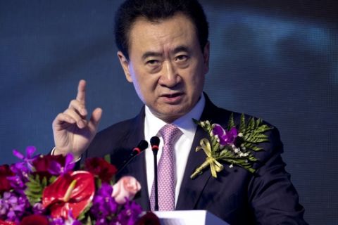 In this April 26, 2017 photo, Chinese billionaire and Wanda Group Chairman Wang Jianlin speaks during an event for the signing of a strategic partnership between Wanda and the Abbott World Marathon Majors in Beijing. Chinese conglomerate Wanda Group, owner of Hollywood's Legendary Studios, is selling most of its theme parks, retreating from a business it once said would challenge Walt Disney Co. (AP Photo/Mark Schiefelbein)