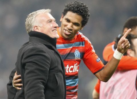 Marseille Brazilian forward Brandao, second left, celebrates with his coach Didier Deschamps at the end of a Champions League, round of 16, second leg soccer match, between Inter Milan and Marseille at the San Siro stadium in Milan, Italy, Tuesday, March 13, 2012. Substitute Brandao's stoppage-time goal sent Marseille through to the Champions League quarterfinals for the first time since 1993 on the away goals rule as a frantic finale saw the Ligue 1 side lose 2-1 at Inter Milan. (AP Photo/Antonio Calanni)