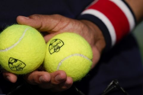 A ball boy stands at attention while holding balls at the Western & Southern Open tennis tournament, Saturday, Aug. 22, 2020, in New York. (AP Photo/Frank Franklin II)