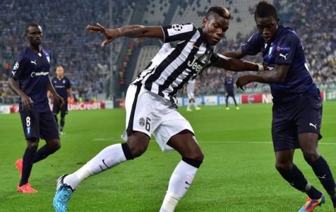 Malmo's defender Pa Konate fights for the ball with Juventus French midfielder Paul Labile Pogba (L) during the UEFA Champions League football match Juventus vs Malmo at "Juventus Stadium" in Turin on September 16, 2014. AFP PHOTO / GIUSEPPE CACACE        (Photo credit should read GIUSEPPE CACACE/AFP/Getty Images)