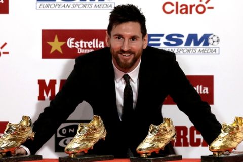 FC Barcelona's Lionel Messi poses with his his fourth Golden Shoe award after receiving his fourth Golden Shoe award for leading all of Europe's leagues in scoring last season in Barcelona, Spain, Friday, Nov 24, 2017. Messi scored 37 goals in the Spanish league last season. It was the fourth time the Barcelona forward has received the honor. (AP Photo/Manu Fernandez)