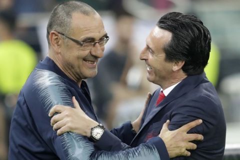 Chelsea head coach Maurizio Sarri, left, shares a moment with Arsenal manager Unai Emery during the Europa League Final soccer match between Arsenal and Chelsea at the Olympic stadium in Baku, Azerbaijan, Wednesday, May 29, 2019. (AP Photo/Luca Bruno)