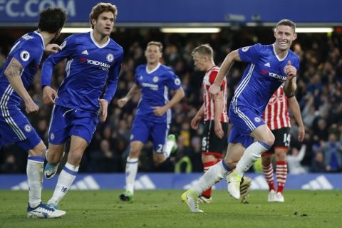 Chelsea's Gary Cahill, right, celebrates scoring a goal during the English Premier League soccer match between Chelsea and Southampton at Stamford Bridge stadium in London, Tuesday, April 25, 2017. (AP Photo/Alastair Grant)