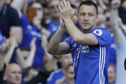 Chelsea captain John Terry applauds the fans wearing his winners medal after they won the league, following the English Premier League soccer match between Chelsea and Sunderland at Stamford Bridge stadium in London, Sunday, May 21, 2017. (AP Photo/Frank Augstein)