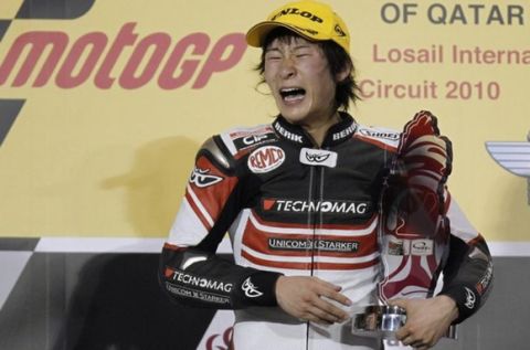Suter rider Shoya Tomizawa of Japan holds up his trophy on the podium after winning the Moto2 race during the Qatar Grand Prix at the Losail international circuit in Doha in this April 11, 2010 file photo. Japanese Moto2 rider Shoya Tomizawa has died after suffering a shocking crash during the San Marino Grand Prix, Italy's Mediaset television said on September 5, 2010. Picture taken April 11, 2010.  REUTERS/Fadi Al-Assaad/Files (QATAR - Tags: SPORT MOTOR RACING OBITUARY)