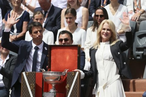Actress Nicole Kidman and French Olympic champion Tony Estanguet present the men's trophy before Spain's Rafael Nadal plays Switzerland's Stan Wawrinka in their final match of the French Open tennis tournament at the Roland Garros stadium, Sunday, June 11, 2017 in Paris. (AP Photo/David Vincent)