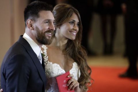 Newlyweds Lionel Messi and Antonella Roccuzzo pose for photographers after tying the knot in Rosario, Argentina, Friday, June 30, 2017. About 250 guests, including teammates and former teammates of the Barcelona star, attended the highly anticipated ceremony. (AP Photo/Victor R. Caivano)