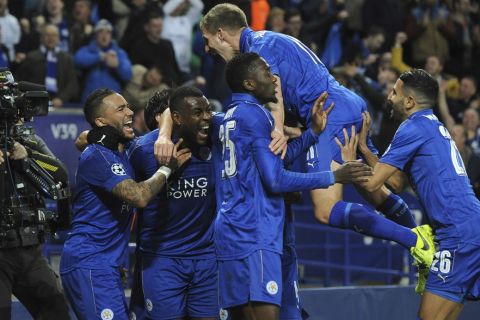 Leicester's Wes Morgan, second left, celebrates with team mates after he scores a goal during the Champions League round of 16 second leg soccer match between Leicester City and Sevilla at the King Power Stadium in Leicester, England, Tuesday, March 14, 2017. (AP Photo/Rui Vieira)