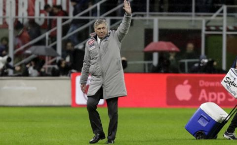 Napoli's head coach Carlo Ancelotti waves to supporters as he walks off the pitch at the end of the Serie A soccer match between AC Milan and Napoli, at the San Siro stadium in Milan, Italy, Saturday, Nov. 23, 2019. The match ended 1-1. (AP Photo/Luca Bruno)