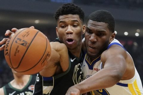 Milwaukee Bucks' Giannis Antetokounmpo and Golden State Warriors' Kevon Looney go after a loose ball during the first half of an NBA basketball game Friday, Dec. 7, 2018, in Milwaukee. (AP Photo/Morry Gash)
