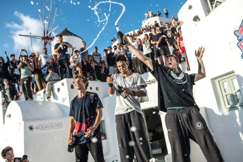 Pavel Petkuns of Latvia, Dimitris Kyrsanidis of Greece (winner) and Jesse Peveril of Canada celebrate during the award ceremony of "Red Bull Art of Motion" freeruning competition in Santorini Island, Greece on October 3, 2015.