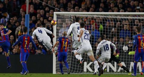 Real Madrid's Sergio Ramos, third left, heads the ball to score his side's first goal during the Spanish La Liga soccer match between FC Barcelona and Real Madrid at the Camp Nou stadium in Barcelona, Spain, Saturday, Dec. 3, 2016. Ramos scored the equalizer goal and the match ended in a 1-1 draw. (AP Photo/Francisco Seco)