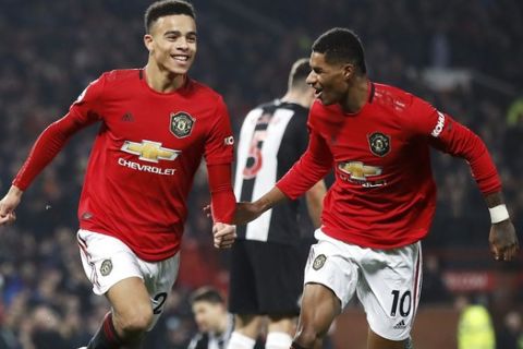Manchester United's Mason Greenwood celebrates scoring his side's second goal of the game with teammate Marcus Rashford during their English Premier League soccer match against Newcastle United at Old Trafford, Manchester, England, Thursday, Dec. 26, 2019. (Martin Rickett/PA via AP)