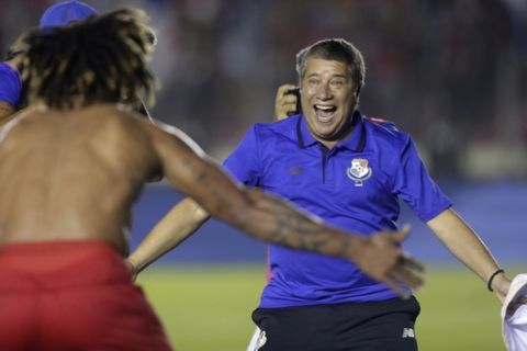 Panama's coach Hernan Dario Gomez, from Colombia, celebrates with his player Roman Torres who scored his team's second goal, after a 2018 Russia World Cup qualifying soccer match against Costa Rica in Panama City, Tuesday, Oct. 10, 2017. (AP Photo/Arnulfo Franco)