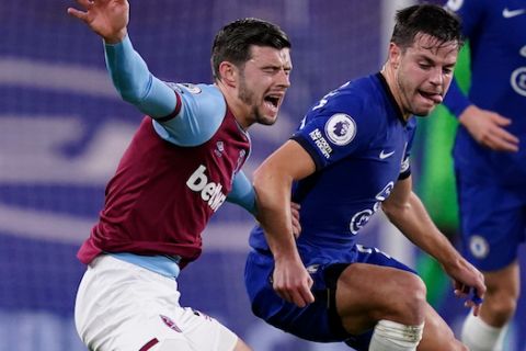 West Ham's Aaron Cresswell, left, reacts as he competes for the ball with Chelsea's Cesar Azpilicueta during the English Premier League soccer match between Chelsea and West Ham at Stamford Bridge, London, Monday, Dec. 21, 2020(AP Photo/John Walton,Pool)