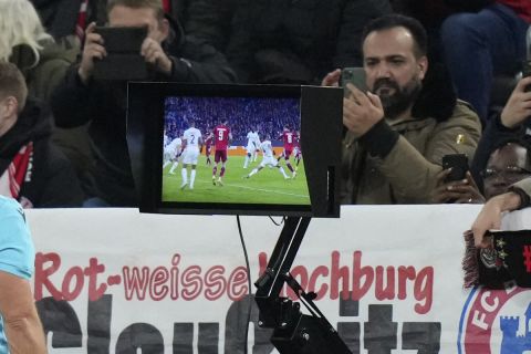 Referee Szymon Marciniak watches the VAR during the Champions League group E soccer match between Bayern Munich and Benfica Lisbon in Munich, Germany, Tuesday, Nov. 2, 2021. Bayern will face Benfica on Tuesday. (AP Photo/Matthias Schrader)