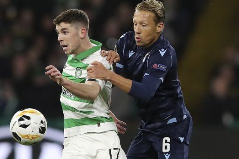 Celtic's Ryan Christie, left, challenges for the ball with Lazio's Lucas Leiva during the Europa League group E soccer match between Celtic and Lazio at Celtic Park stadium in Glasgow, Scotland, Thursday, Oct. 24, 2019. (AP Photo/Scott Heppell)