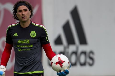 Goalkeeper Guillermo Ochoa warms up during a training session of Mexico's national soccer team, in Mexico City, Wednesday, June 7, 2017. Mexico will play two World Cup qualifying matches at its home Azteca Stadium this week, taking on Honduras on Thursday and the United States on Sunday. (AP Photo/Rebecca Blackwell)