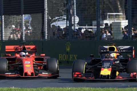 Red Bull driver Max Verstappen of the Netherlands, right, passes Ferrari driver Sebastian Vettel of Germany during the Australian Formula 1 Grand Prix in Melbourne, Australia, Sunday, March 17, 2019. (AP Photo/Andy Brownbill)