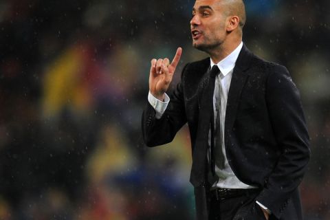 Barcelona's coach Pep Guardiola gestures during the Champions League semi-final second leg football match between Barcelona and Real Madrid at the Camp Nou stadium in Barcelona on May 3, 2011. AFP PHOTO/LLUIS GENE (Photo credit should read LLUIS GENE/AFP/Getty Images)