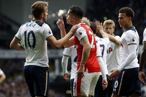 Arsenal's Granit Xhaka, center, shouts at Tottenham Hotspur's Harry Kane, left, after he went down for a penalty during the English Premier League soccer match between Tottenham Hotspur and Arsenal at White Hart Lane in London, Sunday, April 30, 2017. (AP Photo/Alastair Grant)