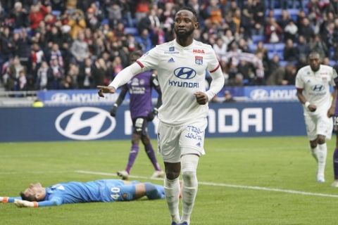 Lyon's Moussa Dembele celebrates after scoring his side's second goal during the French League One soccer match between Lyon and Toulouse in Decines, outside Lyon, central France, Sunday, Jan. 26, 2020. (AP Photo/Laurent Cipriani)