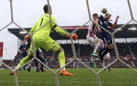 Tottenham Hotspur's Harry Kane attempts to get a touch on his side's second goal scored by team-mate Christian Eriksen during the English Premier League soccer match between Stoke City and Tottenham Hotspur at the bet365 Stadium Stoke, England. Saturday, April 7, 2018, 2018. (Nigel French/PA via AP)