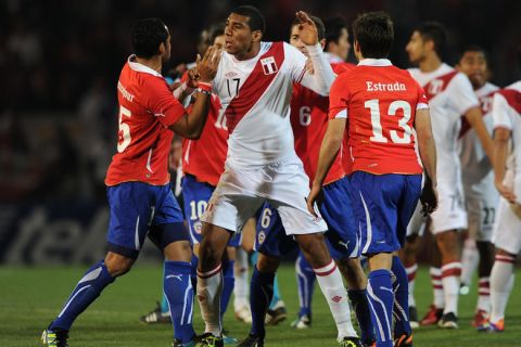Chilean forward Jean Beausejour(L) and Peruvian defender Giancarlo Carmona argue angrily among teammates during a 2011 Copa America Group C first round football match held at the Malvinas Argentinas stadium in Mendoza, 1058 Km west of Buenos Aires, on July 12, 2011. AFP PHOTO / ALEJANDRO PAGNI (Photo credit should read ALEJANDRO PAGNI/AFP/Getty Images)