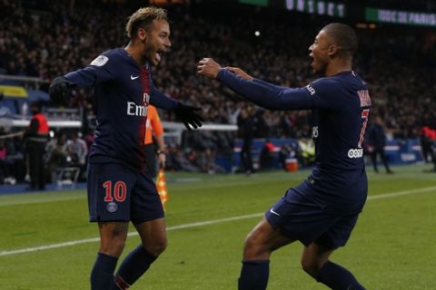 PSG's Kylian Mbappe, right, runs towards PSG's Neymar, celebrating after he scored his side second goal during the League One soccer match between Paris Saint-Germain and Lille at the Parc des Princes stadium in Paris, Friday, Nov. 2, 2018. (AP Photo/Thibault Camus)