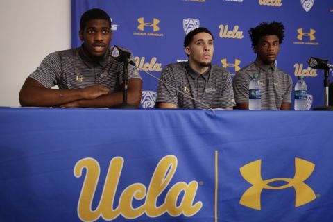 UCLA basketball player Cody Riley, left, reads his statement as he is joined by teammates LiAngelo Ball, center, and Jalen Hill during a news conference at UCLA Wednesday, Nov. 15, 2017, in Los Angeles. Three UCLA NCAA college basketball players accused of shoplifting in China admitted to the crime and apologized before coach Steve Alford announced they were being suspended indefinitely. (AP Photo/Jae C. Hong)