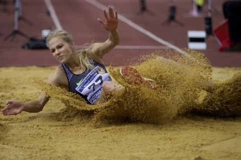 Long jumper Daria Klishina competes at the Russian Winter national athletics meet in Moscow, Russia, Sunday, Feb. 5, 2017. On Monday, track's world governing body, the IAAF, will hold a council meeting with the stated aim of drawing up a road map for Russia's return. (AP Photo/Ivan Sekretarev)