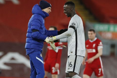 Chelsea's head coach Thomas Tuchel, left, celebrates with his player goalkeeper Edouard Mendy after winning the English Premier League soccer match between Liverpool and Chelsea at Anfield stadium in Liverpool, England, Thursday, March 4, 2021. (Phil Noble, Pool via AP)