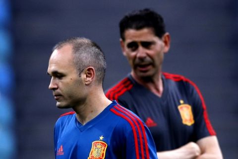 Spain's Andres Iniesta, left, walks next to his coach Fernando Hierro takes part during Spain's official training on the eve of the group B match between Portugal and Spain at the 2018 soccer World Cup in the Fisht Stadium in Sochi, Russia, Thursday, June 14, 2018. (AP Photo/Manu Fernandez)