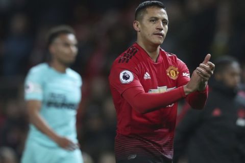 Manchester United's Alexis Sanchez walks from the pitch as he applauds the fans after the end of the English Premier League soccer match between Manchester United and Newcastle United at Old Trafford in Manchester, England, Saturday, Oct. 6, 2018. Man Utd won the game 3-2, with Sanchez scoring a late winner.(AP Photo/Jon Super)